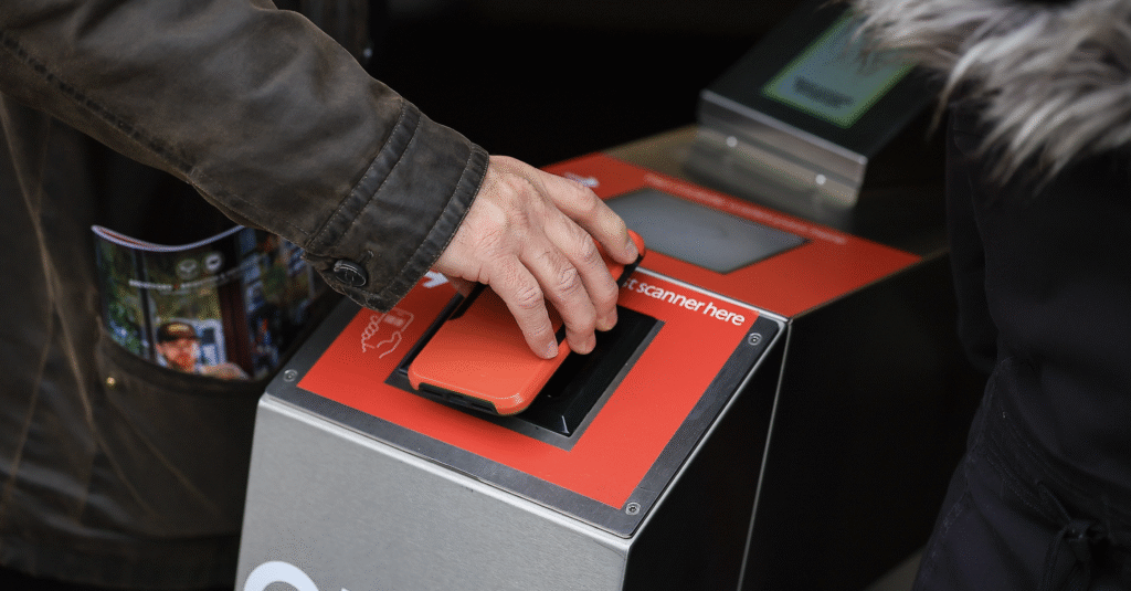 A picture of someone using a digital ticket to enter a Football Stadium